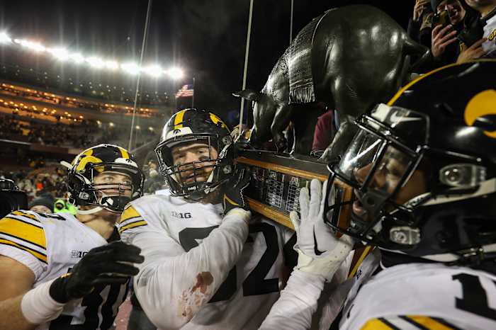 Nov 19, 2022; Minneapolis, Minnesota, USA; Iowa Hawkeyes players celebrate with the Floyd of Rosedale after defeating the Minnesota Golden Gophers at Huntington Bank Stadium. (Matt Krohn-USA TODAY Sports)